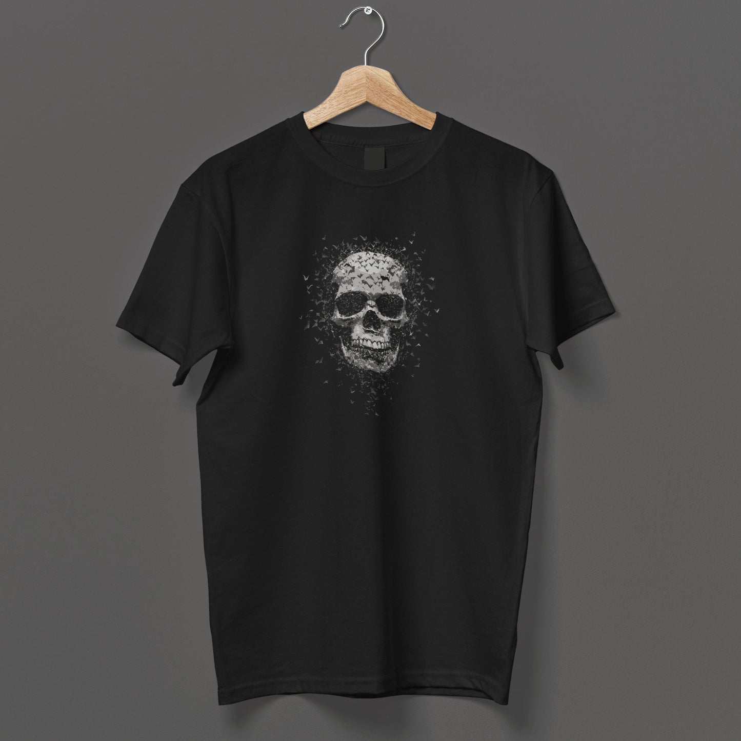Alternative horror t-shirt with monochrome skull dissolving into bat swarm, gothic apparel