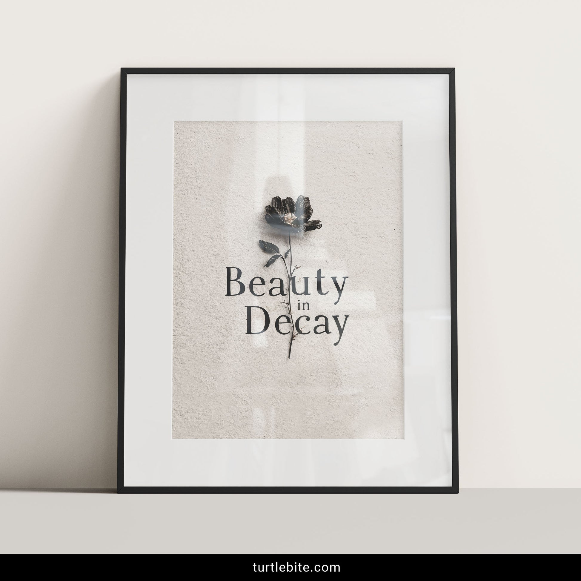 Existential memento mori print displaying wilted dark flower against neutral textured surface with typography