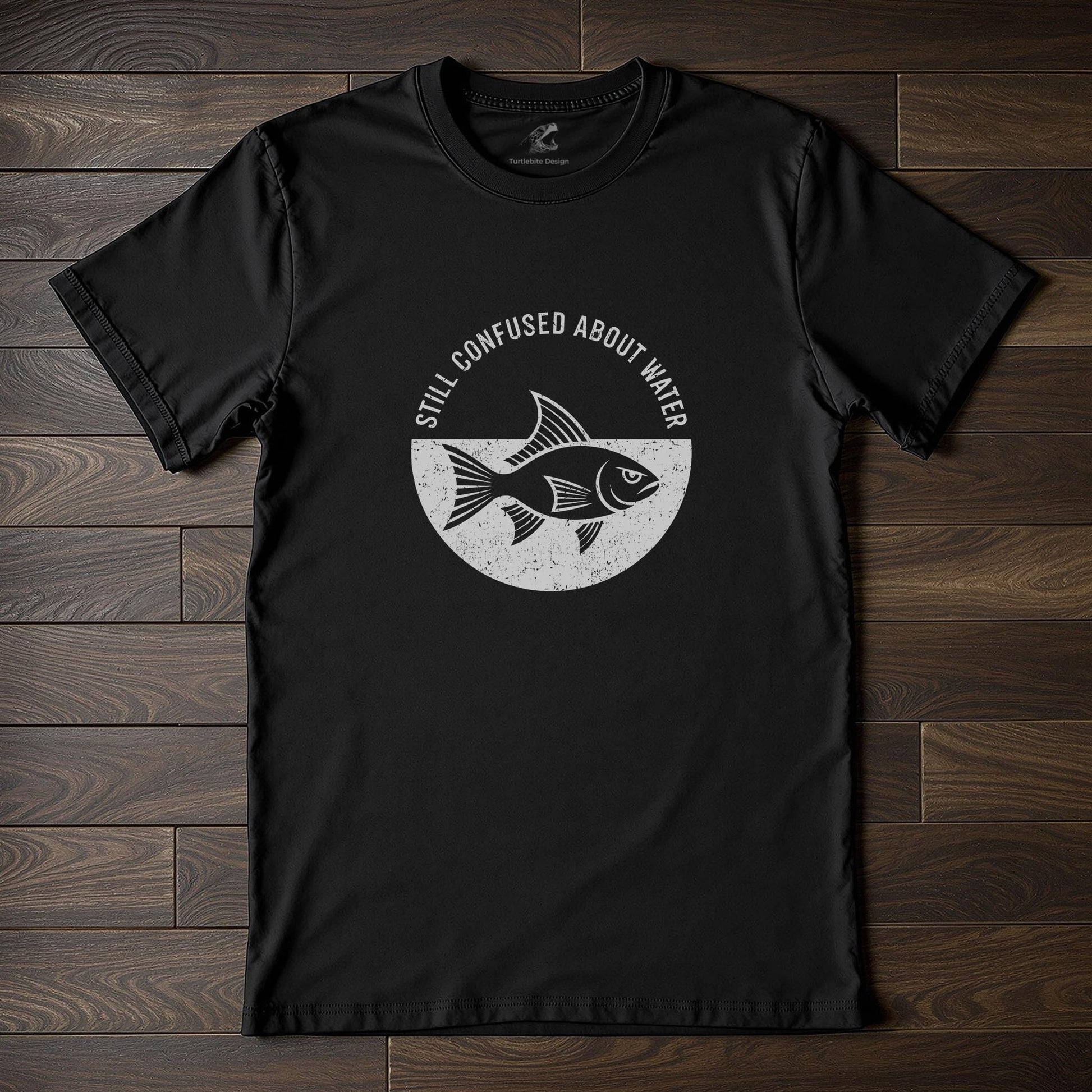 Black t-shirt with white fish graphic and "Still Confused About Water" text for funny conversation starter apparel