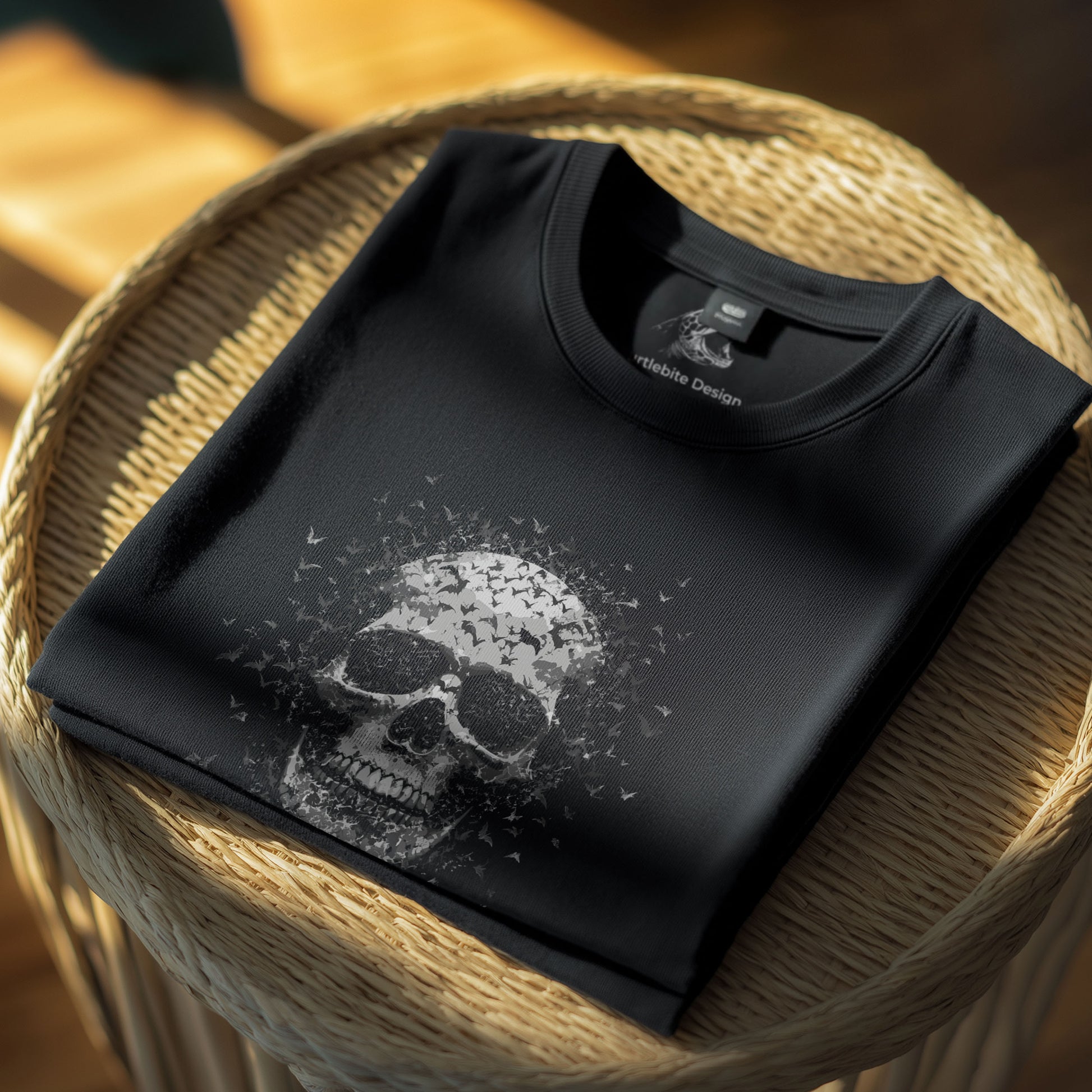 Alternative horror t-shirt with monochrome skull dissolving into bat swarm, gothic apparel