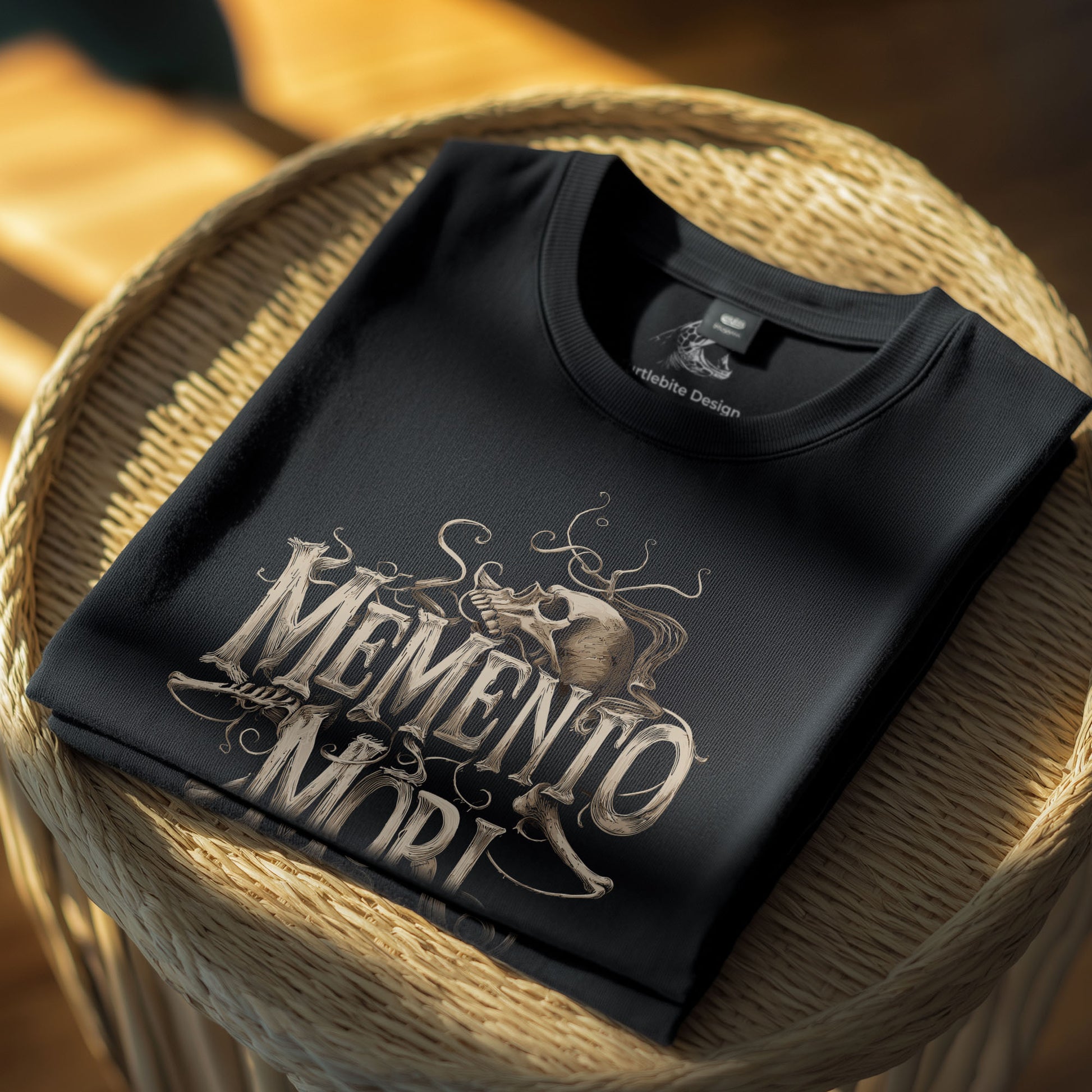 Black t-shirt displaying philosophical skull design with ornate flourishes