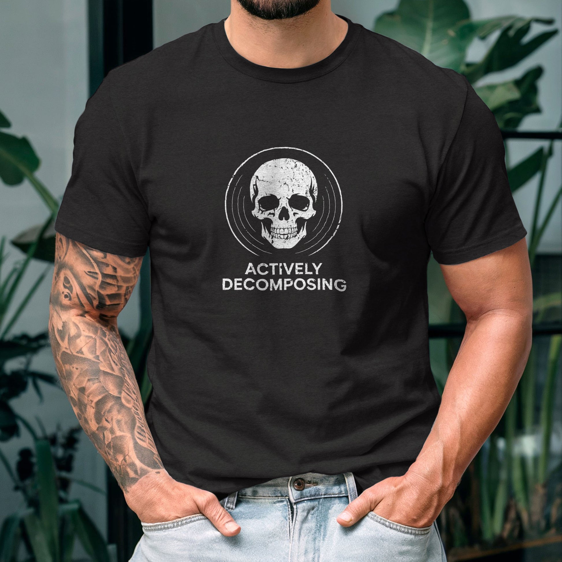 Black t-shirt with white skull graphic and "Actively Decomposing" text for dark humor fashion