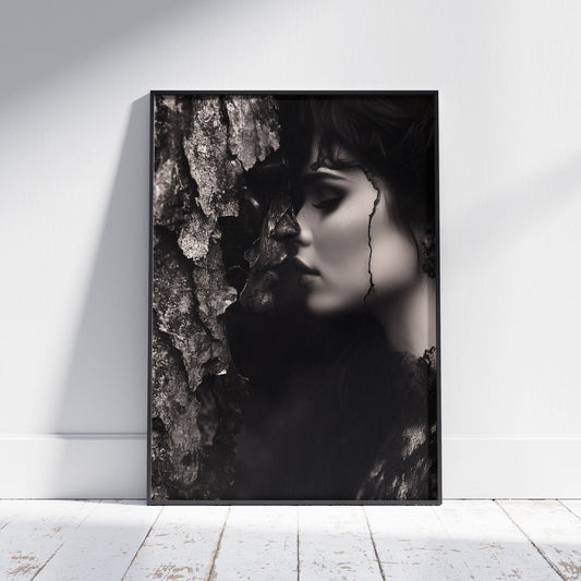 Surreal dark romance art poster showing a woman in black lace leaning toward a tree with a face emerging from the bark in monochrome